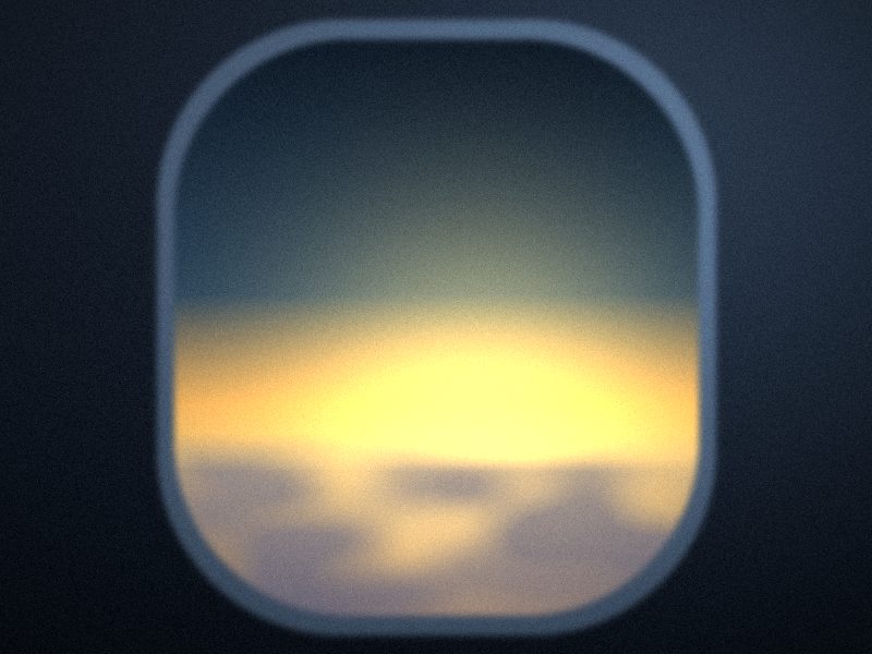 Vue par un hublot d’avion sur une mer de nuages à l’aube